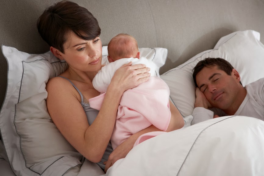 baby in bed with parents